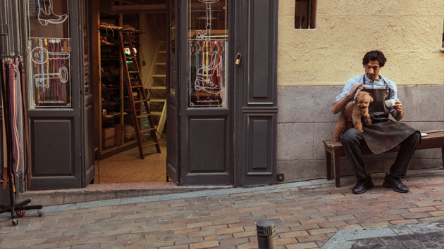 Shoe cobbler taking a break from work