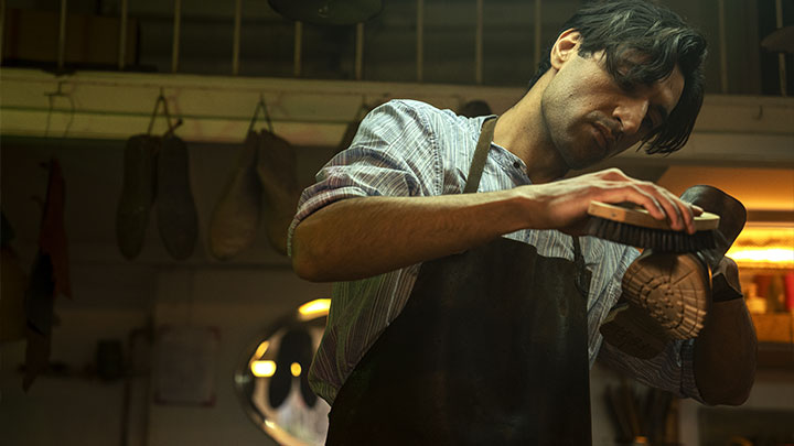 Shoe cobbler waxing shoes