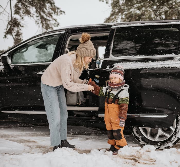 Mother and daughter going on winter drive